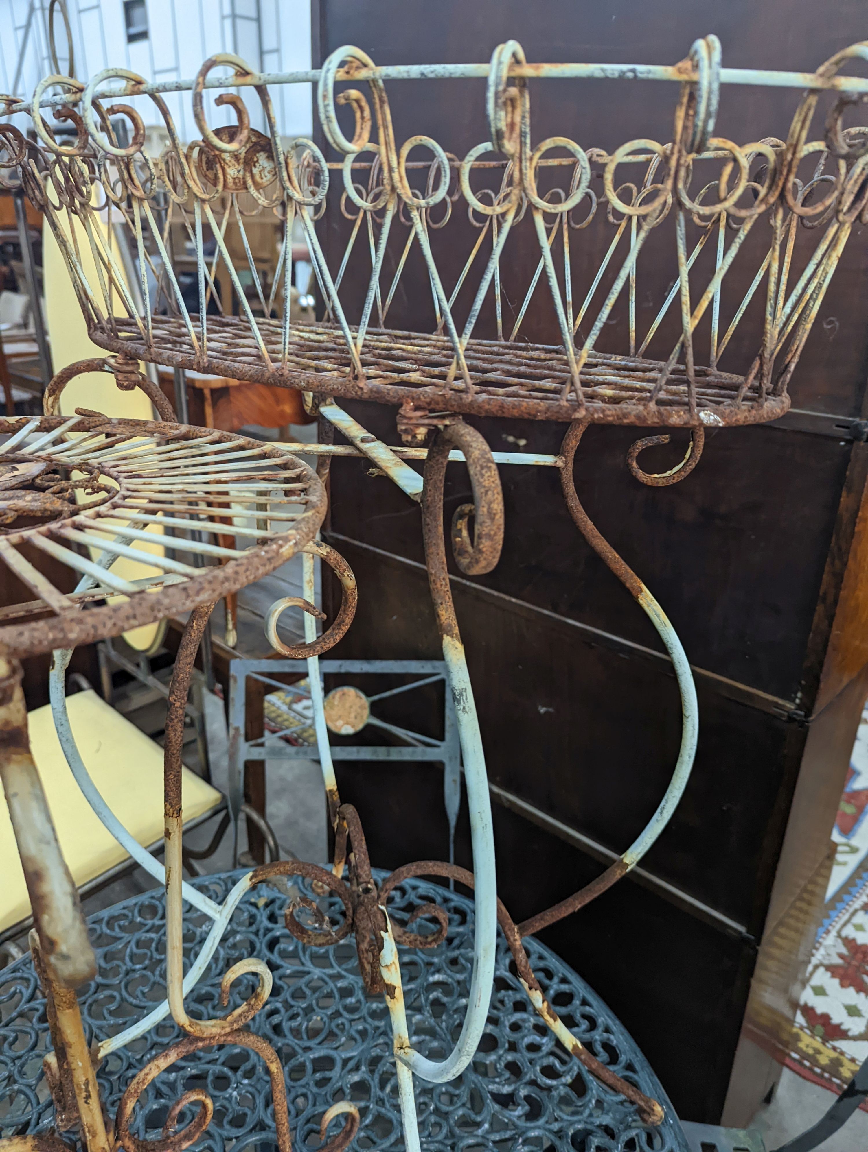 A painted wirework and wrought iron pot stand, height 79cm together with a similar circular table